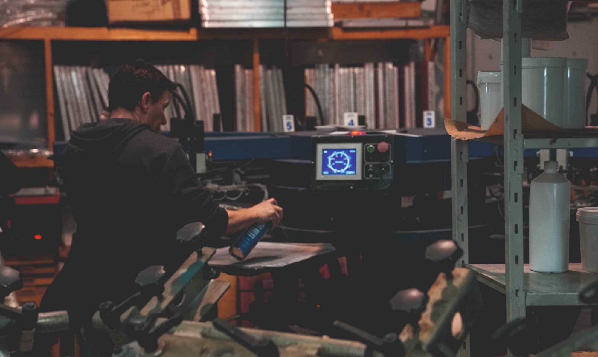 A printer setting up the carousel screen printing press on our Limerick factory floor